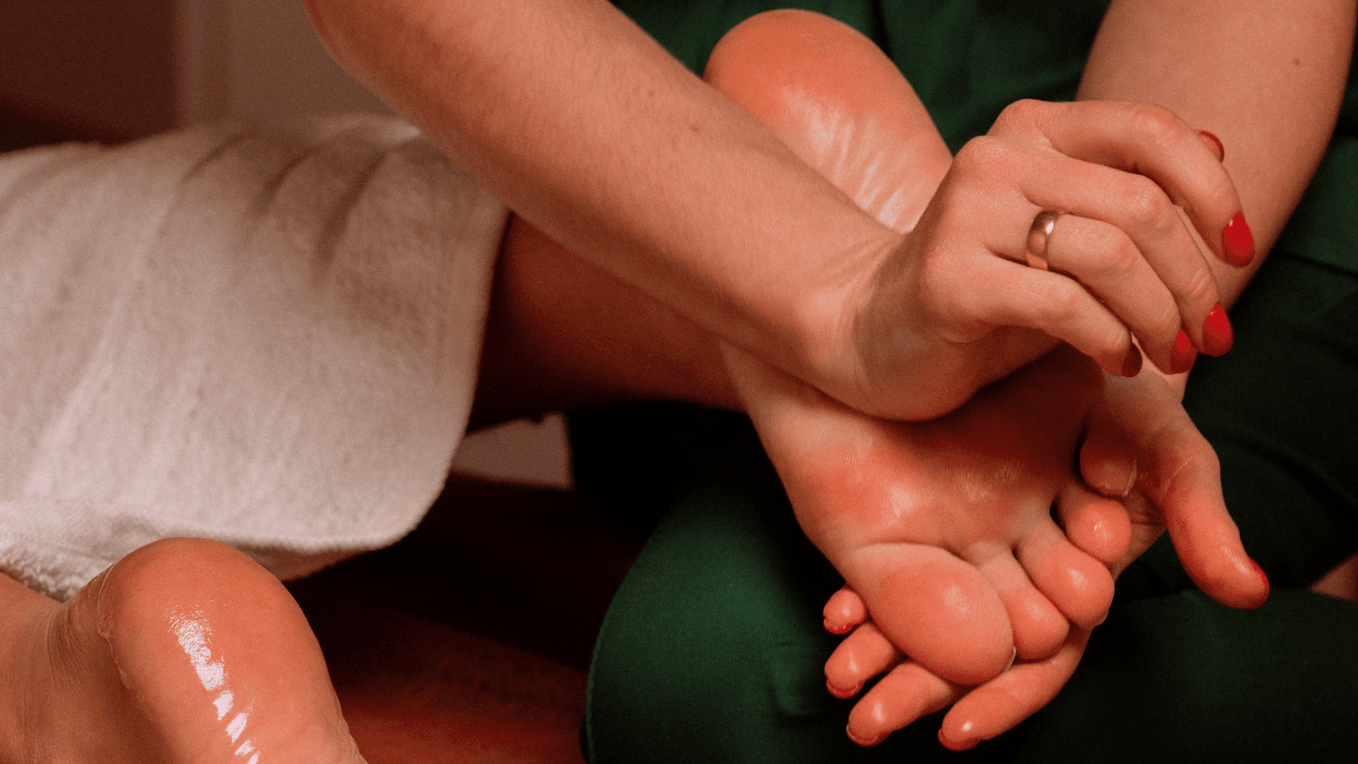 Foot massage therapy session with therapist applying gentle pressure on client's foot.